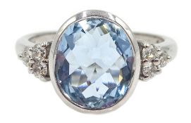 White gold bezel set oval briolette cut aquamarine with round brilliant cut diamond shoulders,