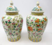 Pair Chinese baluster jars and covers decorated in polychrome enamels with trailing flowers within