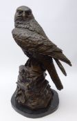 Large bronze model of a Peregrine Falcon perched on rocky base, shaped marble plinth,
