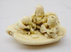 19th century Japanese ivory Netsuke of three figures on a boat reading,