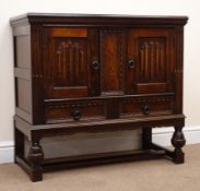 20th century oak side cabinet with carved linen fold doors above two drawers,