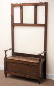 Early 20th century oak hall stand, raised bevelled mirror back with hooks, hinged box seat, W92cm,