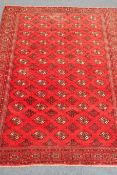 Bokhara red ground rug, repeating elephant foot medallions,