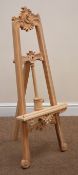 Small hardwood easel, carved scrolls and foliage,