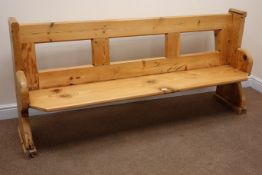 Stripped and waxed pine pew, solid end supports with arched sledge feet,
