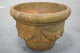 Large circular tapering terracotta planter, with moulded swags D60cm,
