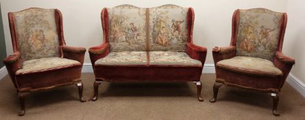 Mid century two seat wingback setter upholstered in a red fabric with needle work back and seat,