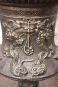 Large bronze finish cast iron garden urn, decorated with foliage swags and dolphins,