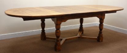 17th century style oak extending dining table with two leaves, curved ends,
