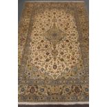 Kashan beige ground rug, central medallion, floral field, repeating border,