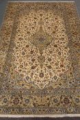 Kashan beige ground rug, central medallion, floral field, repeating border,