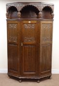 Large early 20th century carved oak hall wardrobe with shaped front, heavily carved,