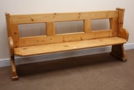 Stripped and waxed pine pew, solid end supports with arched sledge feet,