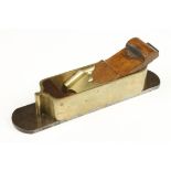 A rare heavy brass mitre plane with d/t steel sole 12" x 2 3/4" with shaped toe and cupids bow