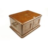 An oak cutlery chest 20" x 16" x 10" comprising three drawers behind two doors with brass handles