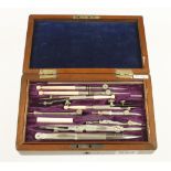 A small drawing set with ivory pens and ivory parallel rule beneath G++