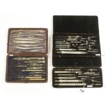 Three part sets of drawing instruments in leather cases,