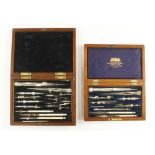 Two sets of drawing instruments in mahogany boxes G