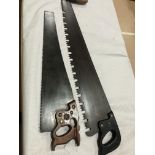 A DISSTON hand saw and a crosscut saw