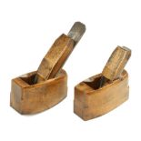 A pair of miniature steel soled beech flat and compassed smoothers,