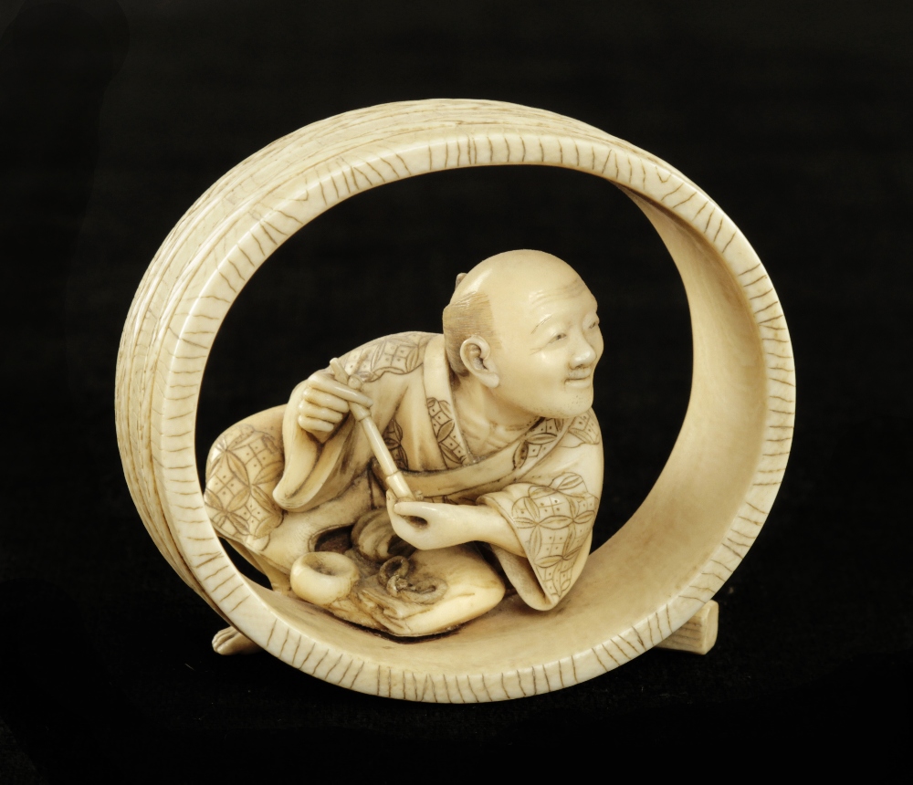 An early Japanese ivory okimono of a barrel maker resting in his unfinished barrel 2 1/2" G+