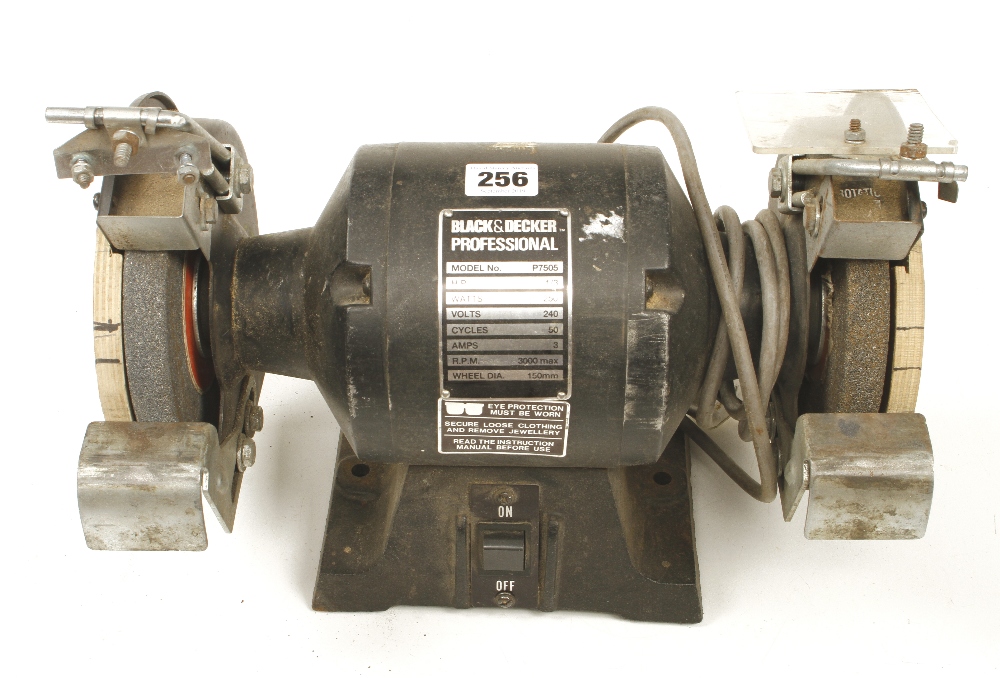 A BLACK and DECKER 6" bench grinder lacks guards ( PAT tested)