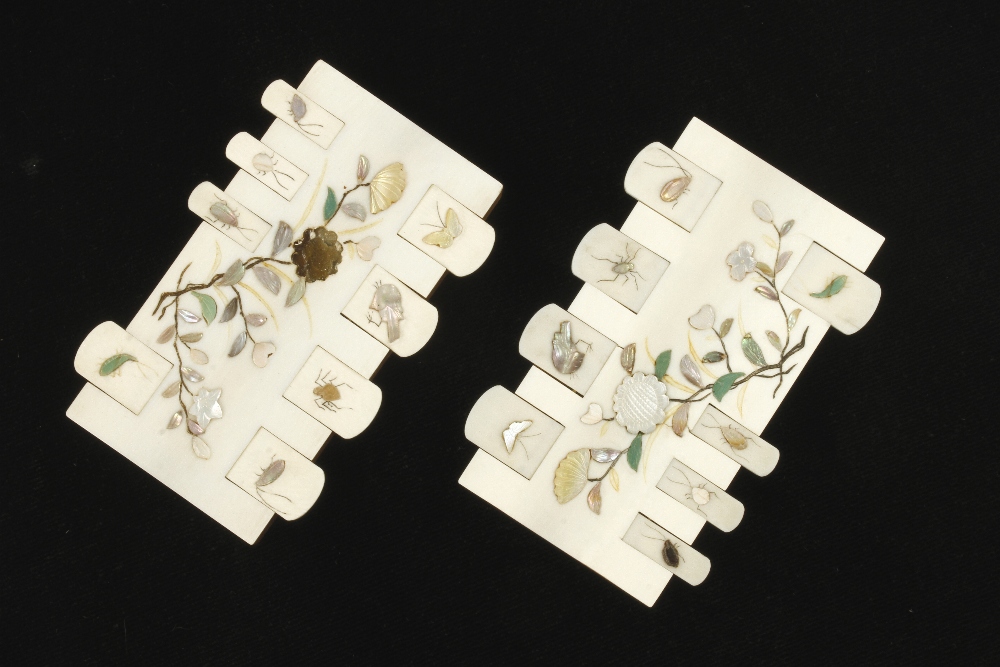 A fine pair of ivory card counters on polished mahogany bases with intricate floral and insect