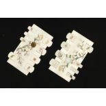 A fine pair of ivory card counters on polished mahogany bases with intricate floral and insect