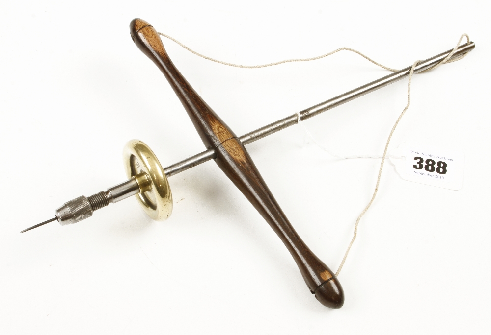 A jeweller's pump drill with brass flywheel and rosewood cross bar stamped "Made by C.V.