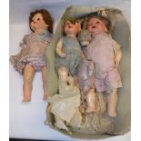 Four composition and plastic dolls as found.