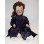 A large baby doll, the porcelain head with sleep eyes,