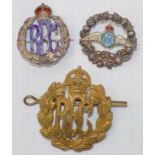 A Royal Flying Corps Cap badge and two Royal Flying Corps silver brooches.