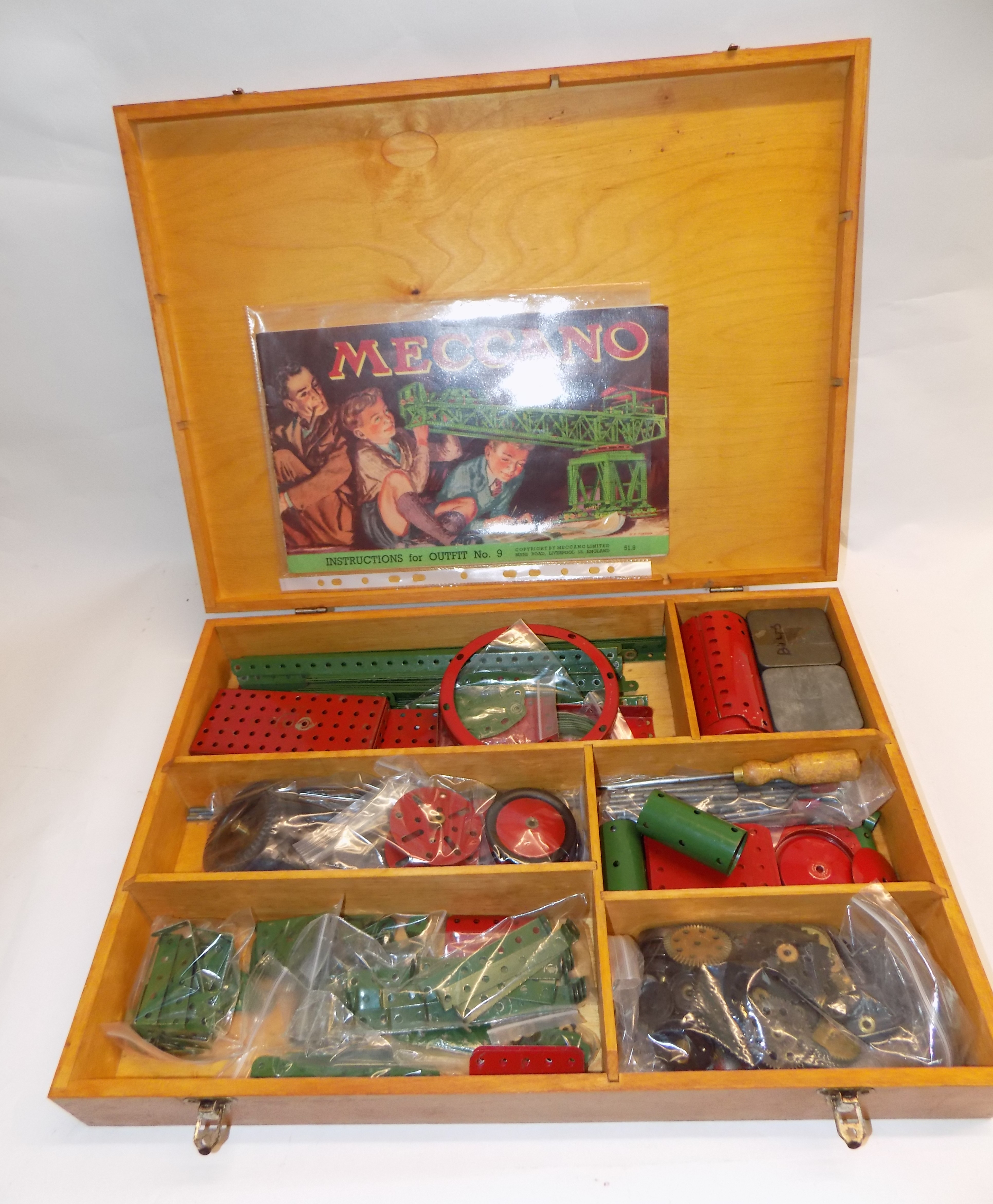 A "Meccano" fitted wood box containing misc red and green parts.