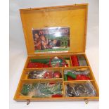 A "Meccano" fitted wood box containing misc red and green parts.