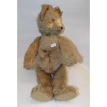 An early 20th century plush teddy bear, the tail articulate the head,