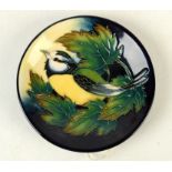 A Moorcroft pottery `Ingleswood Blue Tit` pattern coaster, shape 780, by Philip Gibson,