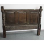 An oak headboard, late 17th/early 18th century, height 107cm, width 133cm.