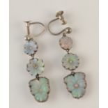 A pair of silver earrings, each with three carved opal flowerheads, the centre of these,