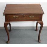 An early 19th century oak lowboy with a single frieze drawer, on cabriole legs with pad feet,
