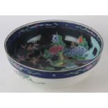 A Chinese famille noir bowl, circa 1900, decorated with bird of paradise, height 11cm, diameter 27.