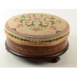 A Victorian parquetry inlaid walnut footstool, with padded needlepoint top and fluted bun feet,