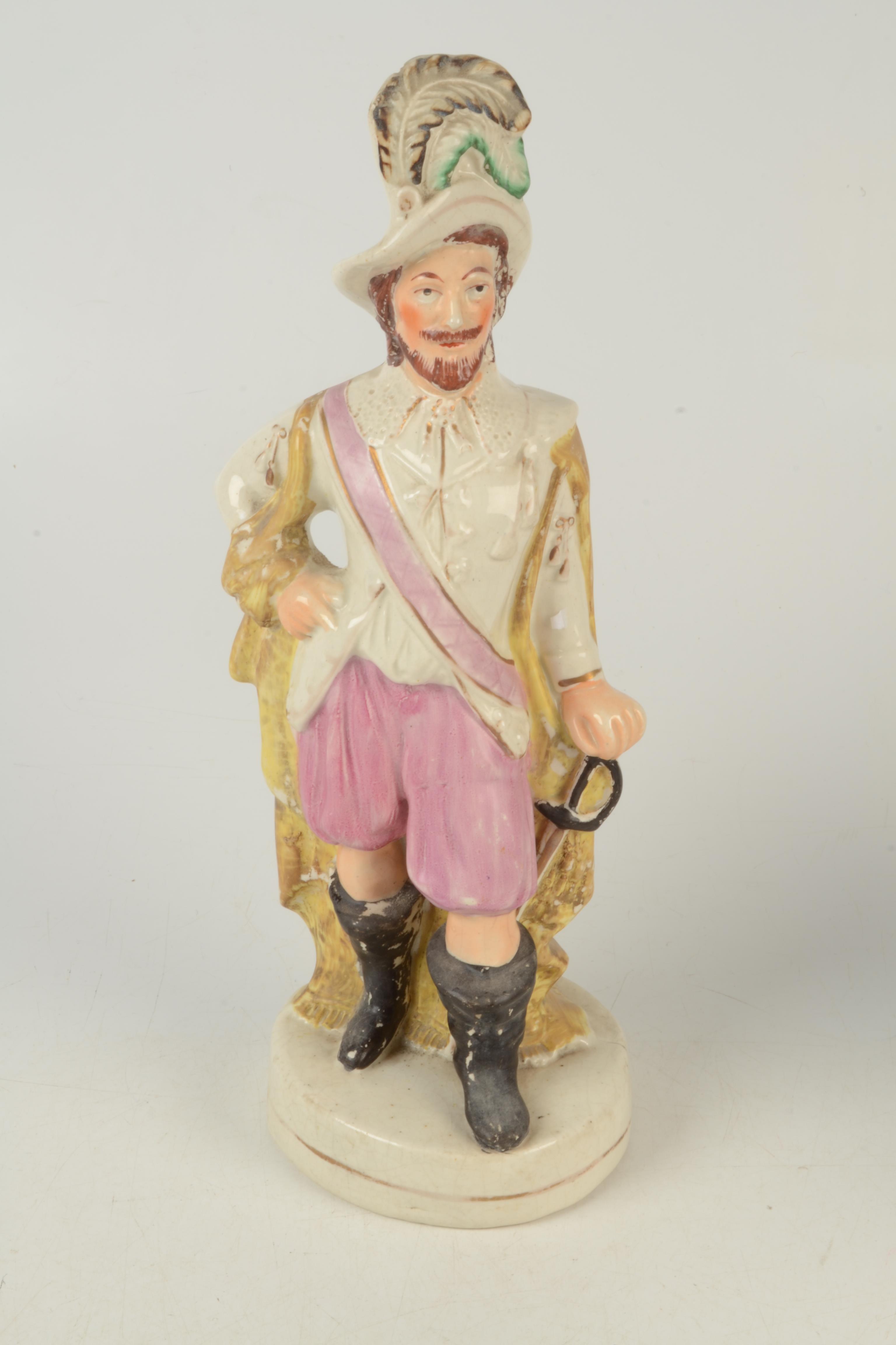 A late Victorian Staffordshire figure, Walter Raleigh with plumed hat and pink pantaloons,