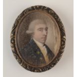 An 18th century portrait miniature of a young be-wigged gentleman with blue coat, 39 x 32mm.