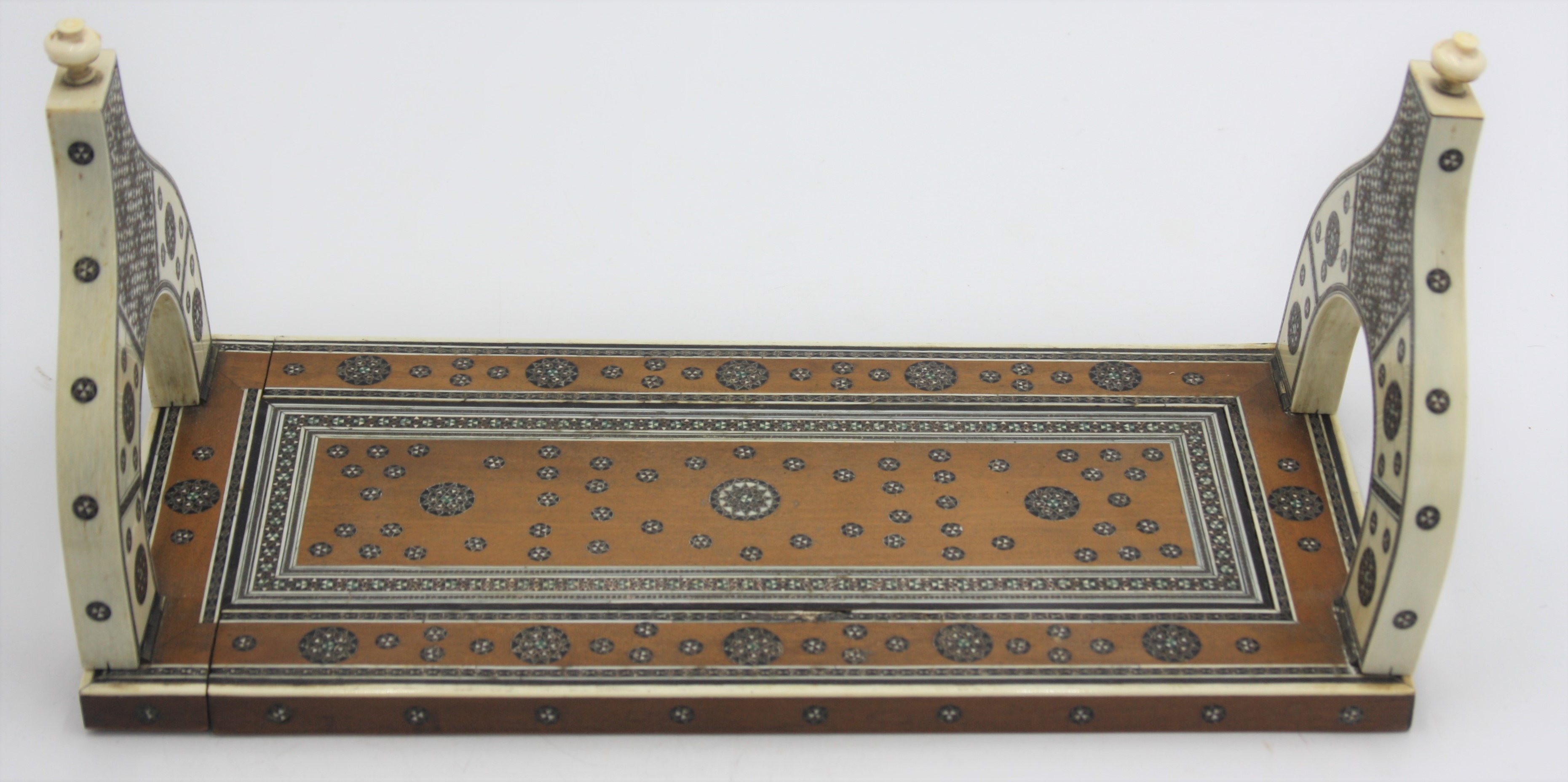 An Anglo-Indian carved sandalwood and ivory adjustable book slide, inlaid with sadeli bands,