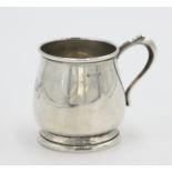 A plain 20th century bellied silver christening mug, 3.3oz.
