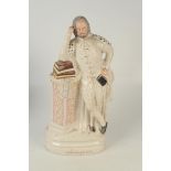 A Victorian large Staffordshire figure Shakespeare, he stands by a marble column,