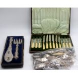 A pair of fish servers cased, a set of six dessert knives and forks cased,