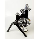 An R & J Beck Ltd London chrome and black lacquered microscope, No 23599, with unusual tripod base,