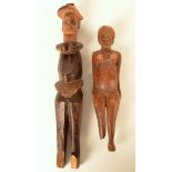 Two carved wood tribal figures, length 29cm and 21.5cm.