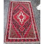 A Hamadan rug, North West Persian, the charcoal field with stylised plants,